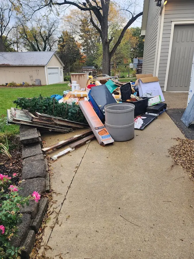 Dumpster being loaded with debris for Residential Dumpster Rental in Sunset Beach